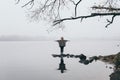 Woman silhouette on the river bank in the morning fog Royalty Free Stock Photo