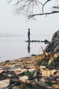 Woman silhouette on the river bank in the morning fog Royalty Free Stock Photo