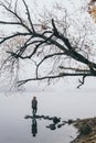 Woman silhouette on the river bank in the morning fog Royalty Free Stock Photo