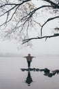 Woman silhouette on the river bank in the morning fog Royalty Free Stock Photo