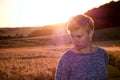 Woman Silhouette at sunset against the sun and a corn field in the background Royalty Free Stock Photo