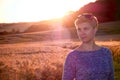 Woman Silhouette at sunset against the sun and a corn field in the background Royalty Free Stock Photo