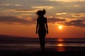 Woman silhouette in sunset beach