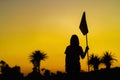 Woman silhouette with sunset over palm trees on the golf course Royalty Free Stock Photo