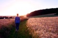 Woman Silhouette walking a gravel path at sunset against the sun Royalty Free Stock Photo