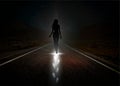 Girl walking at night and leaving bright light foot prints