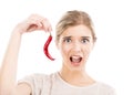 Woman with a silly face holding a red chilli pepper Royalty Free Stock Photo