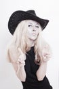 Woman with silver make-up in a cowboy hat