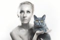 Woman with silver makeup on face holding gray cat