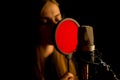 Woman singer with headphones recording in studio. Royalty Free Stock Photo