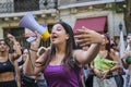 Woman singing, cheering her peers using a megaphone during the feminist strike