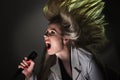 Woman singing into a microphone