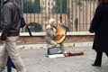 Woman singing and playing harp outdoors on the building site near colosseum in Rome