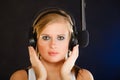 Woman singing to microphone wearing headphones in studio Royalty Free Stock Photo