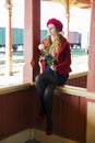 Woman sit on boundaries at train station