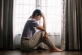 woman sit Depression Dark haired pensive glance Standing by window and anxiety Copy space Royalty Free Stock Photo