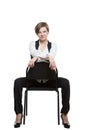 Woman sits astride a chair. shows wrist