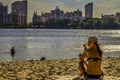 A woman sits on the beach