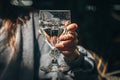 A woman in a cafe holds a glass of water in her hand. Royalty Free Stock Photo