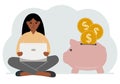 A woman sits cross-legged with a laptop next to a pig piggy bank. Earning money, saving, saving money. Royalty Free Stock Photo