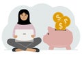 A woman sits cross-legged with a laptop next to a pig piggy bank. Earning money, saving, saving money. Royalty Free Stock Photo