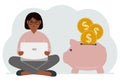 A woman sits cross-legged with a laptop next to a pig piggy bank. Earning money, saving, saving money. Royalty Free Stock Photo