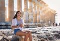 Woman sits in front of the Acropolis of Athens, Greece Royalty Free Stock Photo