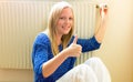 Woman sits in front of radiators