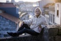 A woman sits on a masonry wall in an old European city. Royalty Free Stock Photo