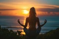 A woman sits in a meditation pose on the beach, her eyes closed, facing the ocean as the sun sets, A woman practicing yoga at