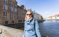 Woman sits near water on Jan van Eyck Square in Bruges, Belgium Royalty Free Stock Photo