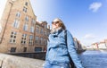 Woman sits near water on Jan van Eyck Square in Bruges, Belgium Royalty Free Stock Photo