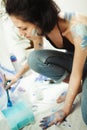 Woman sits in pofile and works on watercolor painting Royalty Free Stock Photo