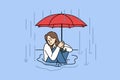 Woman sits in puddle in rain and holds umbrella over head, trying to escape autumn downpour Royalty Free Stock Photo