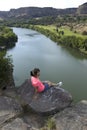 Woman sits on rock overlooking Snake River Royalty Free Stock Photo