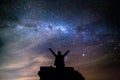 Silhouetted person hails the cosmos milky way starry night sky Royalty Free Stock Photo