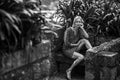 A woman sits on a stone bench in an old park, Porto, Portugal. Black and white photo. Royalty Free Stock Photo