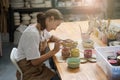 Woman sits at a table and paints a plate Royalty Free Stock Photo