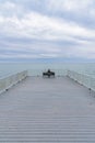 Woman sitting alone on bench looking at Lake Michigan Royalty Free Stock Photo