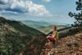 Woman Sitting Alone on Cliff Rock of Mountain Royalty Free Stock Photo