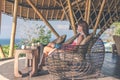 Woman sitting in bamboo restaurant. Original place. Space for text. Bali island.