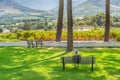 A woman sitting on a bench and looking over the vineyards at Franschhoek
