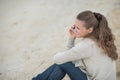 Woman sitting on beach and talking mobile phone Royalty Free Stock Photo