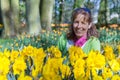 Woman sitting behind daffodils in park