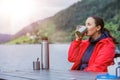 Woman sitting on the bench and enjoying the view on a fjord in Norway