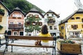 woman sitting on the bench at hallstatt city central square