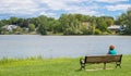 Woman sitting by a lake in Massachusetts Royalty Free Stock Photo