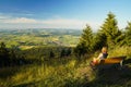 A woman sitting on a bench, looking from mount Hohenbogen to Neukirchen Heiligblut, a small town in the Bavarian Forest Royalty Free Stock Photo