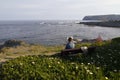 Woman sitting in a bench, next to the sea Royalty Free Stock Photo