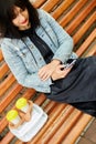 Woman sitting on the bench in the park with take away food and coffee Royalty Free Stock Photo